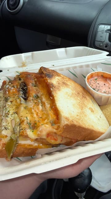 A creator visits Toasted in Bruntsfield, Edinburgh, providing a tour of the interior, showing the menu, and reviewing their toastie order with a close-up cheese pull.