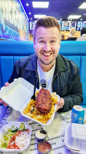 The creator visits a newly opened Mr. Cod takeaway in Woodley, highlighting its modern interior design, graffiti art, and menu offerings. He interacts with the staff and performs a taste test of the burger and masala fish, providing a positive review of the experience.