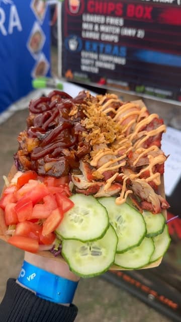 A short promotional video for a street food vendor called Smoky Bites, featuring a shot of their menu and the assembly of a loaded rice box with grilled chicken and BBQ pork.
