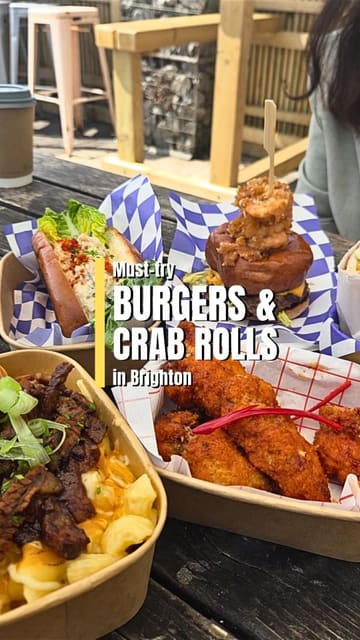A vlog-style review of Puffin at The Tempest in Brighton, featuring a variety of dishes including a surf and turf burger, brisket mac and cheese, crab roll, chicken katsu sando, and buffalo chicken tenders. The creator highlights the outdoor seating on the seafront and the menu variety.