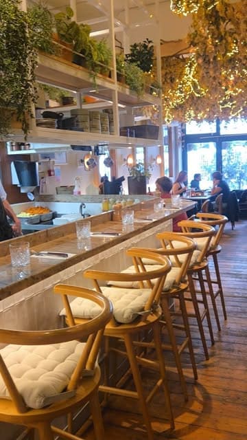 A vlog-style review of a restaurant called Kindling in Brighton, featuring the creator and her mother trying various dishes including steak, croquettes, and grilled cabbage.