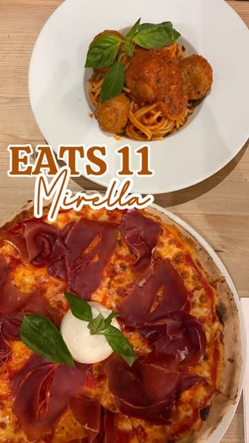 A review of Mirella, an Italian restaurant in Leytonstone, featuring a variety of dishes including cocktails, baked prawns, chicken wings, pizza, spaghetti, and profiteroles.