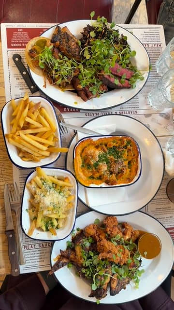 A review-style reel featuring a visit to Chop Shop Bar & Grill, showcasing a variety of meat-heavy dishes including tacos, a butcher's block platter, chicken, and mac and cheese.