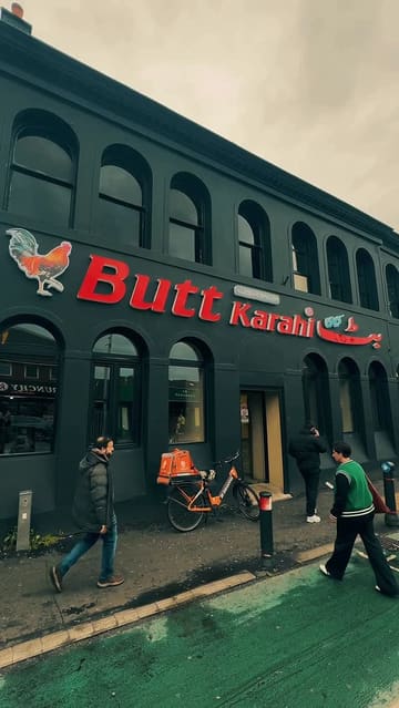 A montage of various Pakistani dishes including a BBQ platter, lamb karahi, and naan, followed by a brief shot of the restaurant's interior featuring a fireplace.