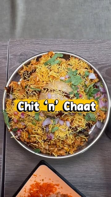 A fast-paced montage showcasing a variety of Indian street food dishes at Chit 'n' Chaat, including vada pav, bhel puri, masala dosa, chicken momos, and various drinks, set against the backdrop of the restaurant's vibrant interior.