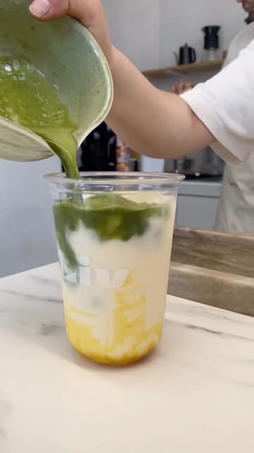 A short, aesthetic montage showcasing the preparation of a mango matcha drink and a lemon meringue cookie at Liv Caffè in Preston.