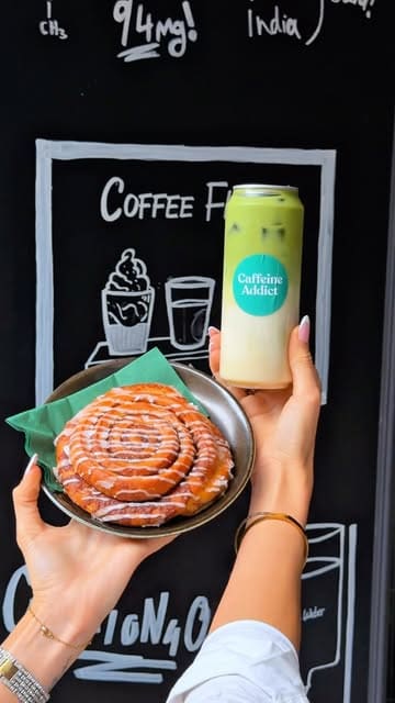 A promotional reel for 'Caffeine Addict' in Leeds, showcasing their coffee flight, various pastries, and build-your-own salad/sandwich lunch options. The creator highlights the cafe's proximity to the train station and the 'lab-crafted' nature of their coffee.