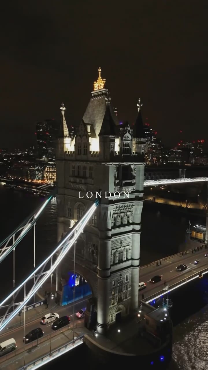 A fast-paced montage video showcasing iconic landmarks in London. The video features various shots of Tower Bridge, Big Ben, the London Eye, and a Westminster Underground station sign, captured at different times of day including daylight, dusk, and night. The clips are set to upbeat, popular music, creating an aspirational and energetic travel-themed video. A consistent text overlay with the word 'LONDON' is present in most scenes.
