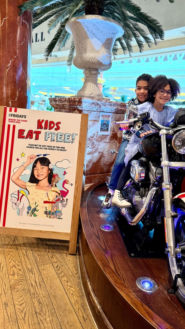 A parent vlogs their visit to TGI Fridays with their children, highlighting the 'Kids Eat Free' promotion, the interactive activity sheets, the DIY sundae station, and the restaurant's kid-friendly atmosphere.