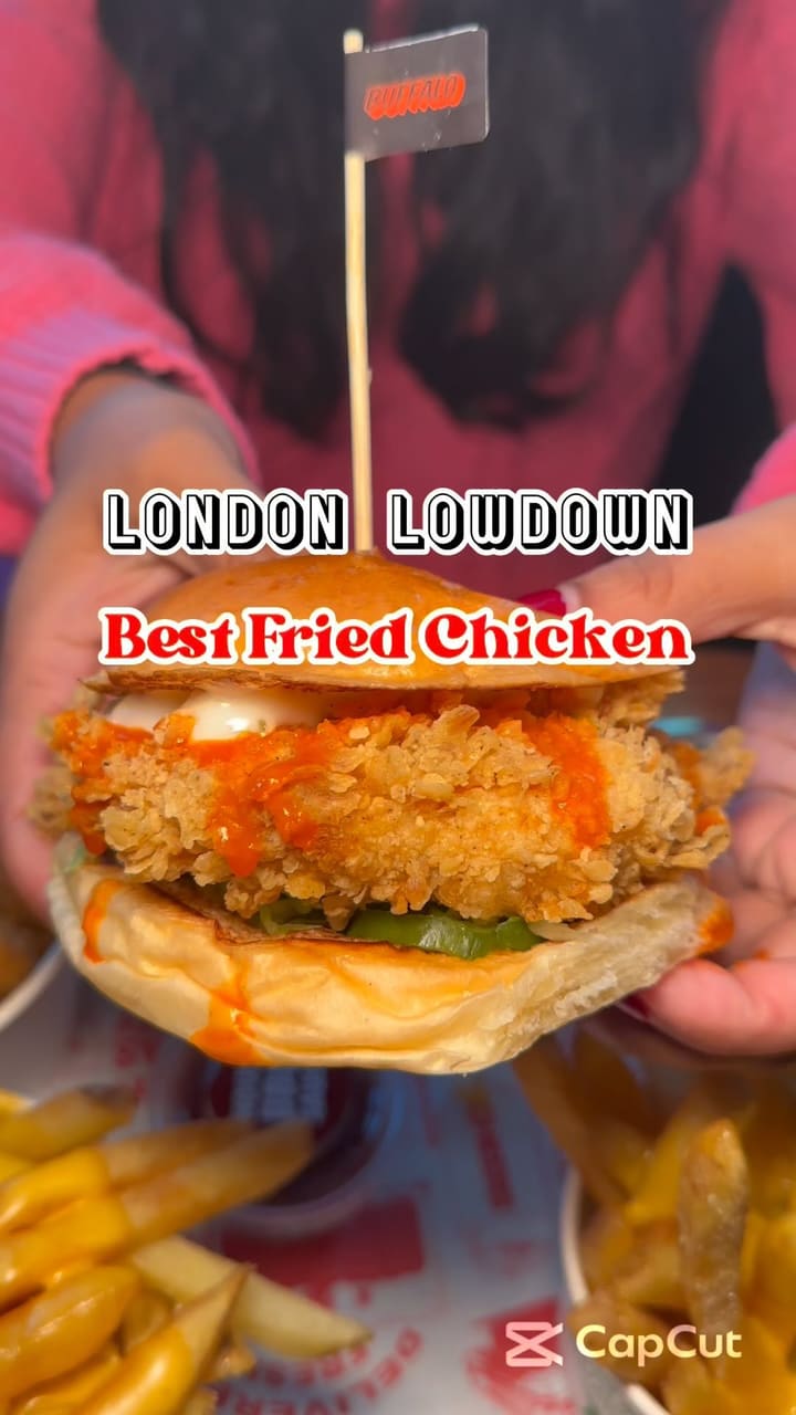The video showcases Butchies Buttermilk Fried Chicken at Canary Wharf's Cargo Market Hall. It features various food items including a buffalo buttermilk fried chicken sandwich, popcorn chicken, cheese fries, and halloumi fries. The food is presented in close-up shots highlighting its textures and colors, emphasizing its appetizing qualities. No dietary information is explicitly provided. The main focus is on the food, with the influencer's reaction included.