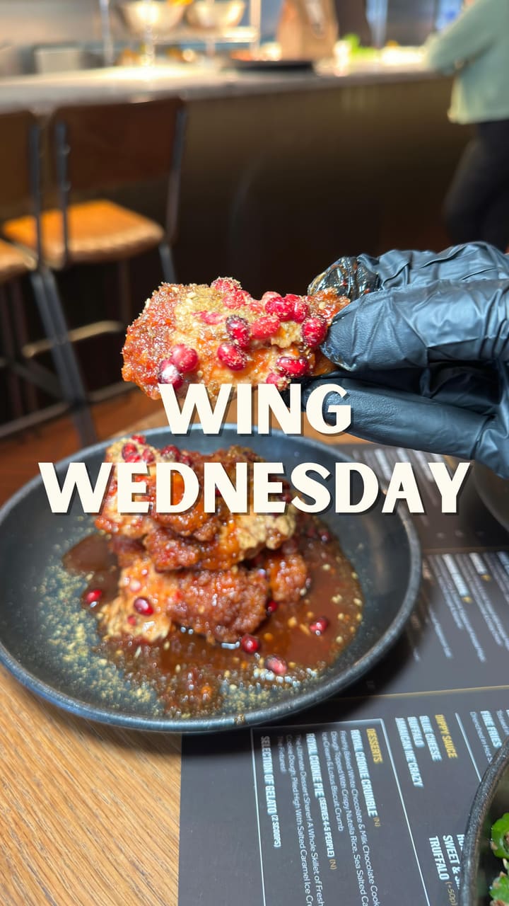 This video showcases Wingmans Shoreditch, a restaurant specializing in chicken wings. It highlights their "Wing Wednesdays" promotion, where customers get a second order of signature wings at half price. The video features various dishes, including Bangcoq Signature Wings (Thai Sriracha, honey, lime, Kewpie mayo, sesame, pickled cucumber), Bird Khalifa Wing Special (garlic, chili caramel, chipotle tahini, pomegranate, zaatar), XL Crispy King Prawns, and the Classic OG burger.  The presentation emphasizes visually appealing food arrangements with vibrant colors and garnishes.  No specific dietary information is provided.