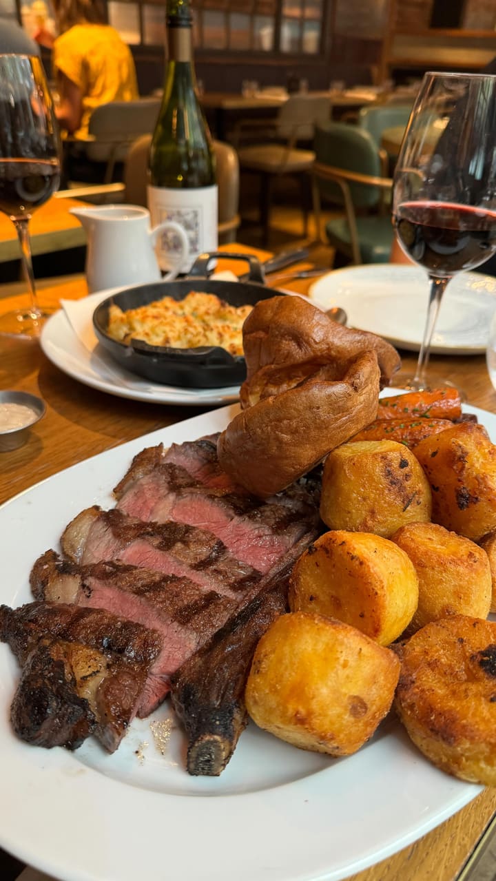 The video showcases a Sunday roast meal at The Coal Shed restaurant in London.  The food includes a 500g roast sirloin of beef, potatoes, cauliflower cheese, Yorkshire puddings, and gravy.  The presentation is visually appealing, with close-up shots highlighting the texture and color of the food. The video also shows the restaurant's exterior and interior. No specific dietary information is provided.