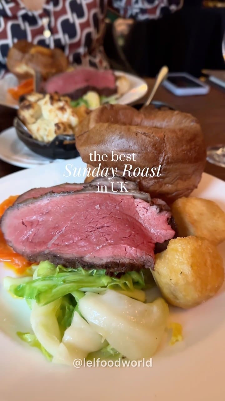 The video showcases Hawksmoor restaurant's Sunday roast. It features various dishes, including roast beef with Yorkshire puddings, roasted potatoes, cauliflower cheese, and a selection of side vegetables. The setting is a high-end restaurant with a sophisticated ambiance. The food presentation is visually appealing, emphasizing high quality ingredients and elegant plating.  The video focuses on the meal itself, highlighting the attractive presentation and the overall dining experience.