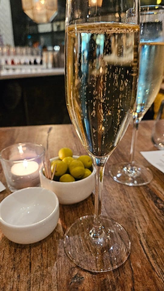 The video showcases a wine tasting experience at Iberica Restaurants in London, featuring wines from Sabaté i Coca.  Each of the four wines (a sparkling white, a rosé, and two reds) is paired with a small dish from the restaurant's deli counter. These pairings include asparagus and cheese toast, croquettes, and a savory spoonful of aubergine based dish.  The video highlights the restaurant's ambiance, wine selection, and food presentation. No specific dietary information is provided.