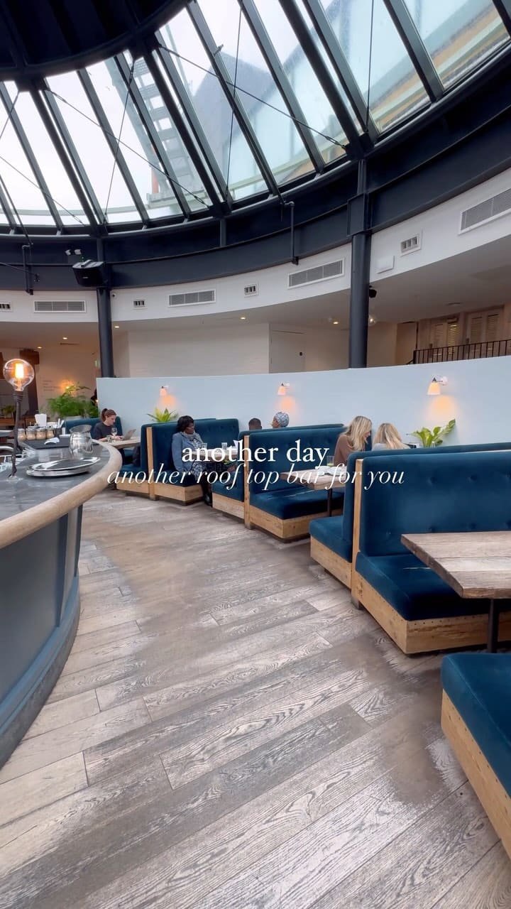 The video showcases The Address, a rooftop bar in Wimbledon. It features various food and drink items, including chicken wings, a burger, a steak sandwich, mac and cheese, cocktails, and bottomless drinks. The presentation is visually appealing, with well-lit and nicely arranged food and drinks. No dietary information is explicitly provided. The main focus is on showcasing the venue's ambiance and menu items.