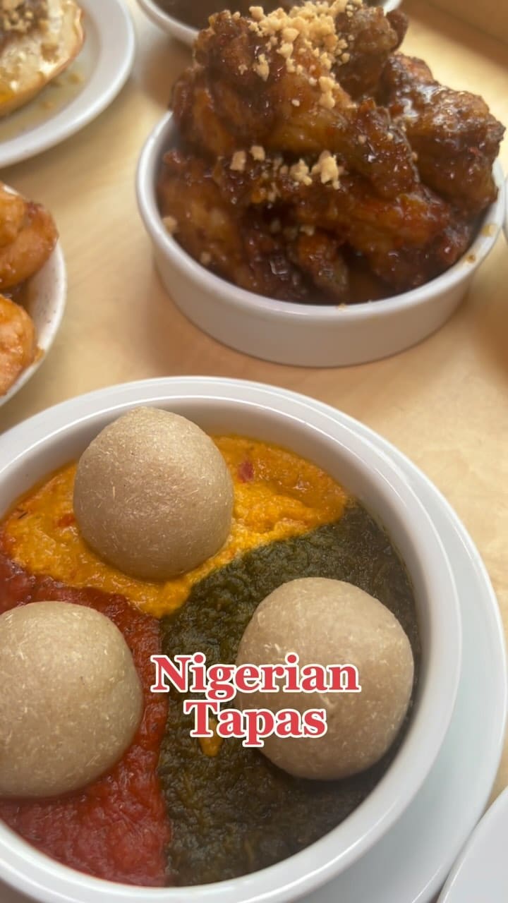 This video showcases Chukus, a Nigerian tapas restaurant in London.  It features various dishes, including spiced shrimp, chicken wings with a peanut topping, and a dish with fufu balls in a three-colored sauce. The video emphasizes the restaurant's brunch menu, highlighting a deal of six sharing plates and six drinks for £40 per person. The restaurant's interior, exterior, and several dishes are showcased.