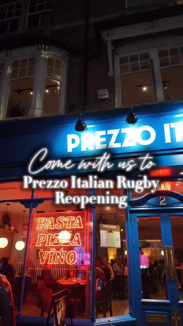 The video promotes the reopening of the Prezzo Italian restaurant in Rugby. It starts with an exterior night shot of the restaurant, then moves inside to display the modern decor, including neon signs and striped booths. The content showcases a variety of cocktails and dishes, such as fried appetizers with a dipping sauce, ravioli and penne pasta being topped with freshly grated parmesan, a baked lasagna-style dish, seasoned fries, and flatbreads. The video concludes with a shot of a chocolate dessert topped with ice cream and sauce.