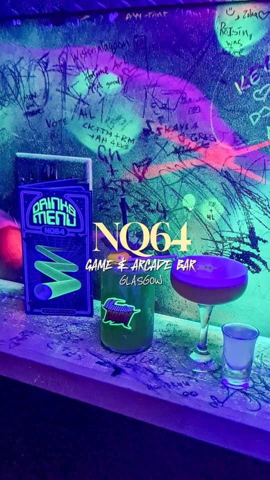 The video showcases NQ64, an arcade bar in Glasgow's Merchant City. It features neon-lit interiors, various arcade games (Mario Kart, a light gun game, Pac-Man, Tekken 3, and Crash Bandicoot), and cocktails presented in coupe glasses and short glasses. The cocktails are visually appealing and vibrant under the neon lights. No specific dietary information is provided. The main focus is on the immersive atmosphere and gaming experience, while also highlighting the cocktails.