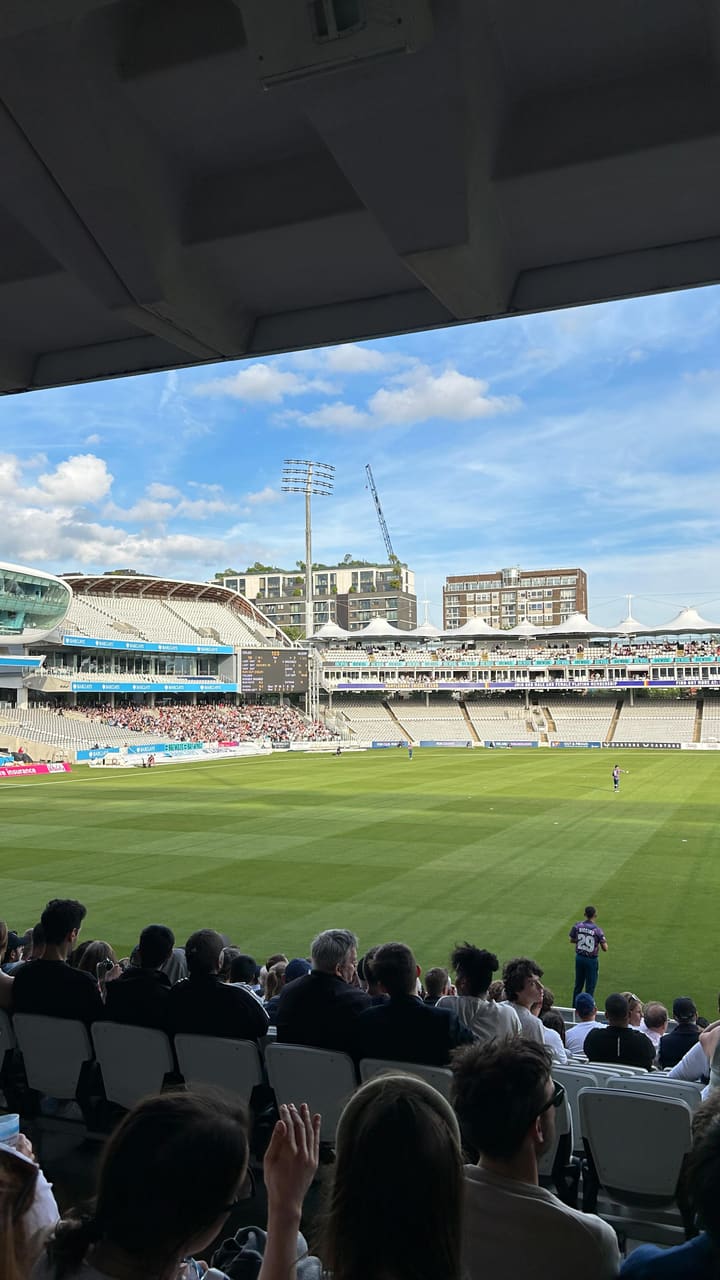 A couple decides to go on a date to a cricket match at Lord's Cricket Ground. The video shows the stadium, the atmosphere, people watching the match, and features shots of beer glasses and a bottle of champagne. It also includes a shot of the Veuve Clicquot bar. The video focuses on the experience of attending the event and enjoying drinks.