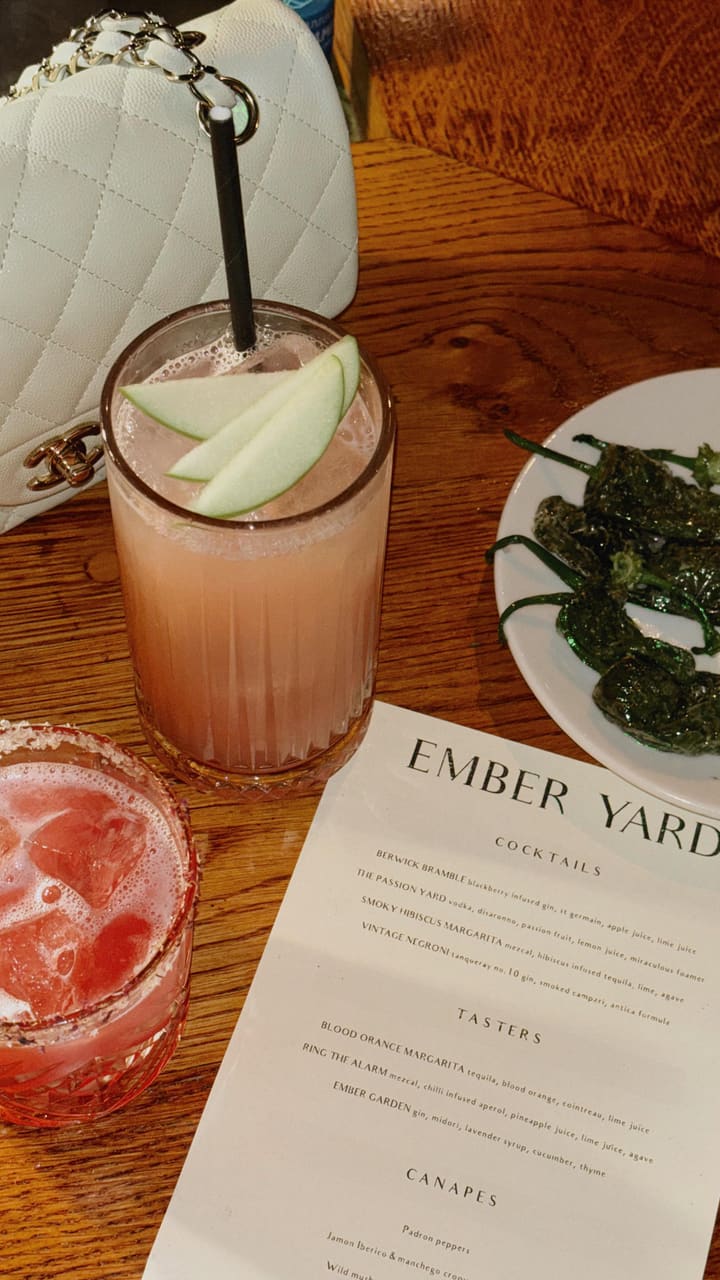 The video showcases the launch of The Ember Bar, a tapas bar in Soho, London. It features cocktails (Smoky Hibiscus Margarita and Berwick Bramble), and a tasting menu from the Head Chef.  Dishes include yellowfin tuna, Padrón peppers, heirloom tomato salad, grilled cod, Tibia Gallega Pinchos, grilled asparagus, grilled secreto ibérico, and coffee cheesecake. The presentation focuses on visually appealing plating and close-ups of the food and drinks.