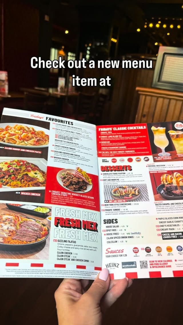 A POV shot of a TGI Fridays menu being held up in a restaurant setting, used to promote new menu items.