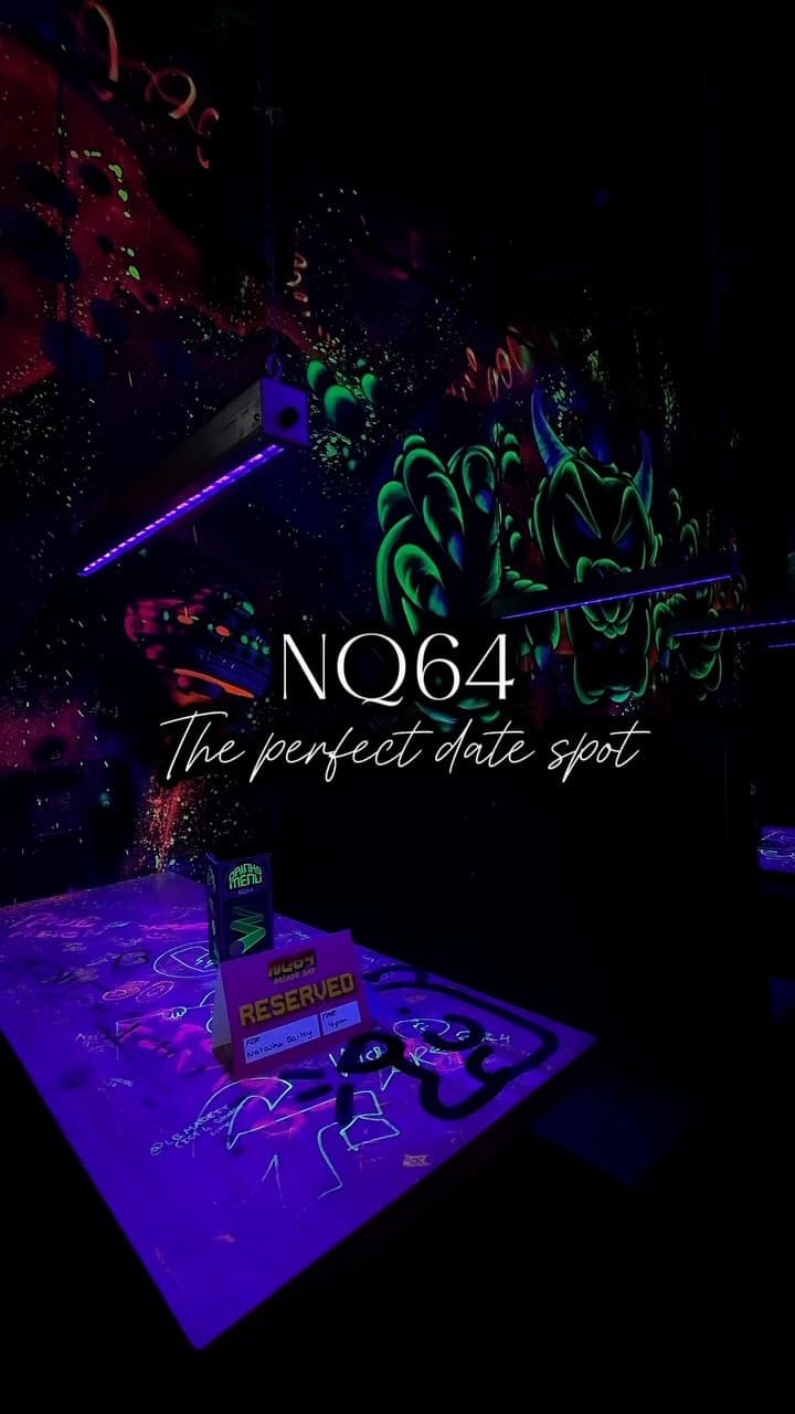 The video showcases NQ64 Arcade Bar in Digbeth, Birmingham. It features a tour of various arcade games and consoles available, including classics like Pac-Man, Tekken 2, Mortal Kombat, Dance Dance Revolution, and consoles such as SNES, Xbox, Playstation, and Nintendo 64. The video emphasizes the nostalgic experience of playing these games, suitable for friends, couples, and families.  No food or drinks are explicitly shown, though the drinks menu is briefly visible. The atmosphere is dark, with neon lighting enhancing the arcade setting.