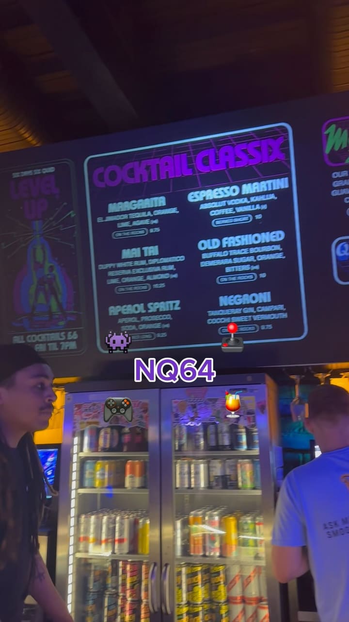 The video showcases NQ64, a bar in Leeds with a retro arcade theme. It features various cocktails (e.g., Mad Max Zombie, Kong Island Iced Tea, Quick Revive No.5), and several arcade games (e.g., Time Crisis II, Pac-Man, Simpsons Arcade). The drinks are presented in unique glasses and garnished creatively. The main focus is to showcase the bar's atmosphere and unique features, combining cocktails and classic arcade games. 